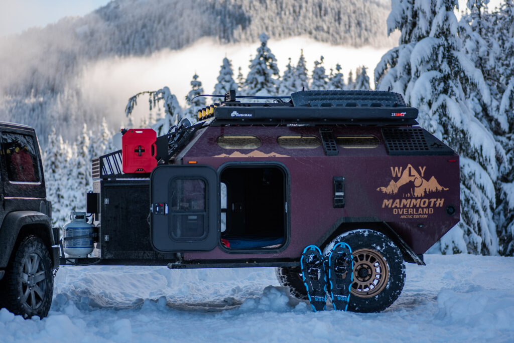 Mammoth Overland WLY off-road trailer in snow with snowshoes leaning against the wheel