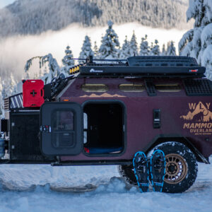 Mammoth Overland WLY off-road trailer in snow with snowshoes leaning against the wheel